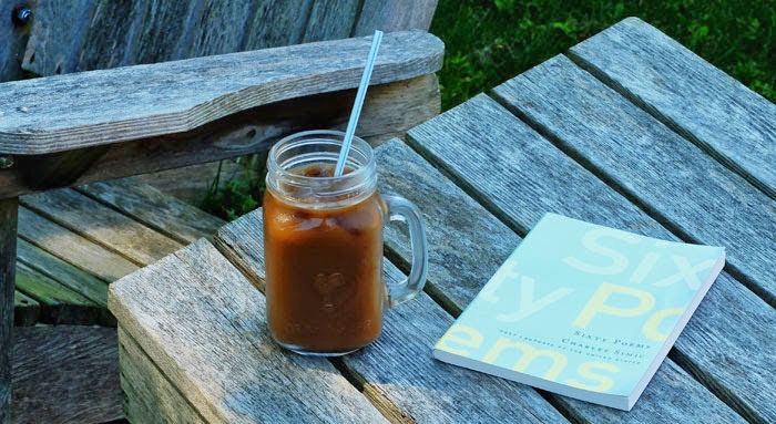 Poetry book with iced coffee in glass